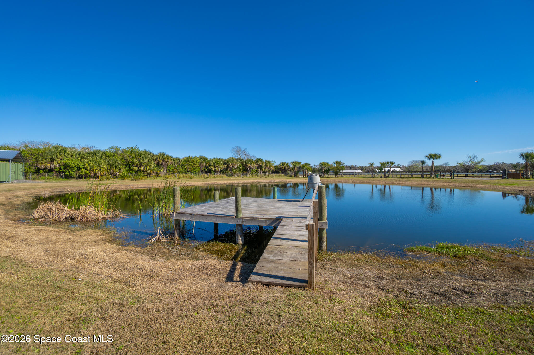 3440 Hammock Road Mims, FL 32754 - Photo 16 of 59 a picture of a lake with houses in the back