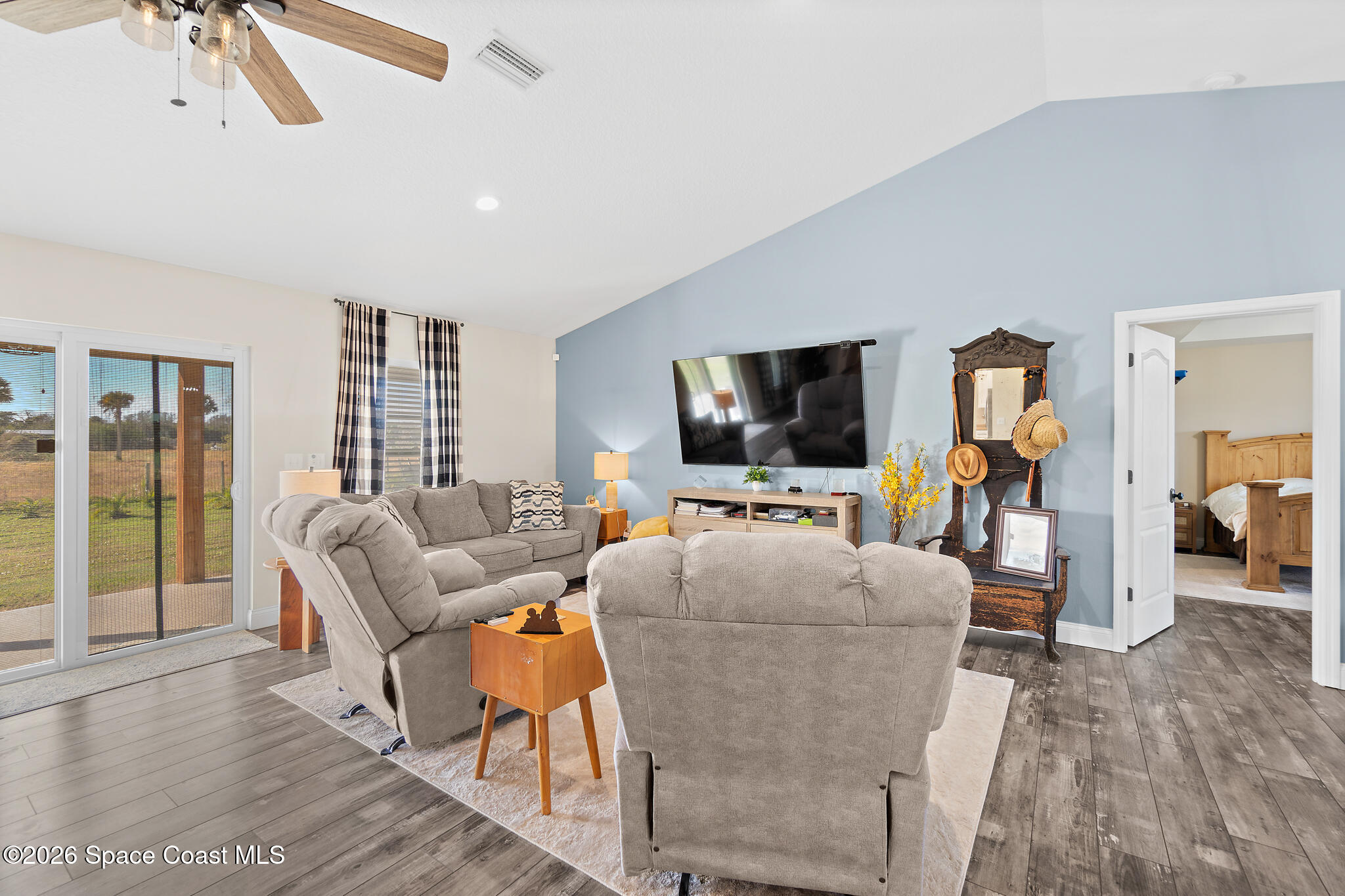 3440 Hammock Road Mims, FL 32754 - Photo 29 of 59 a living room with furniture and a flat screen tv