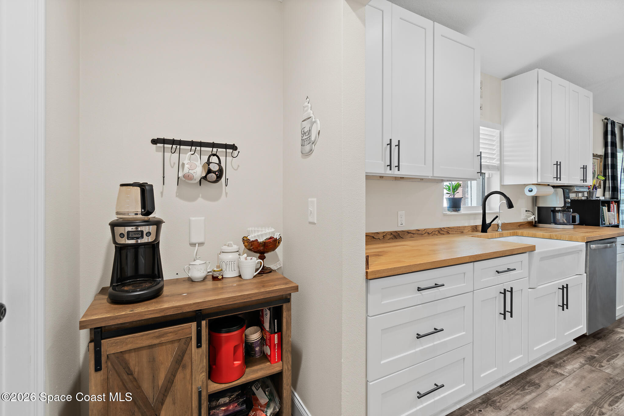 3440 Hammock Road Mims, FL 32754 - Photo 40 of 59 a kitchen with white cabinets and sink