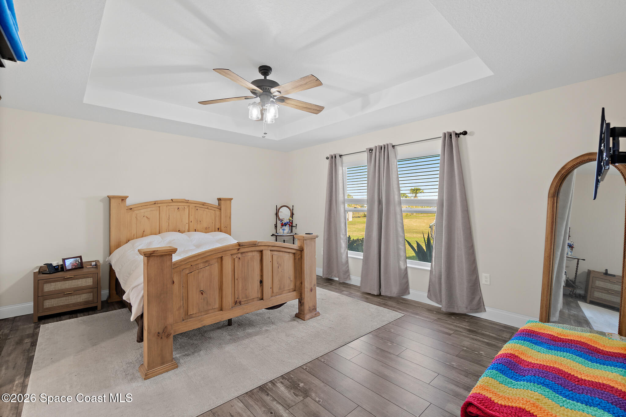 3440 Hammock Road Mims, FL 32754 - Photo 8 of 59 a bedroom with a bed and a chandelier