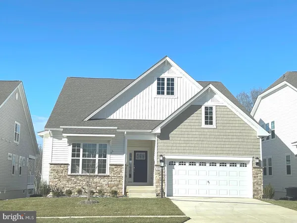 a view of a house with a yard and garage