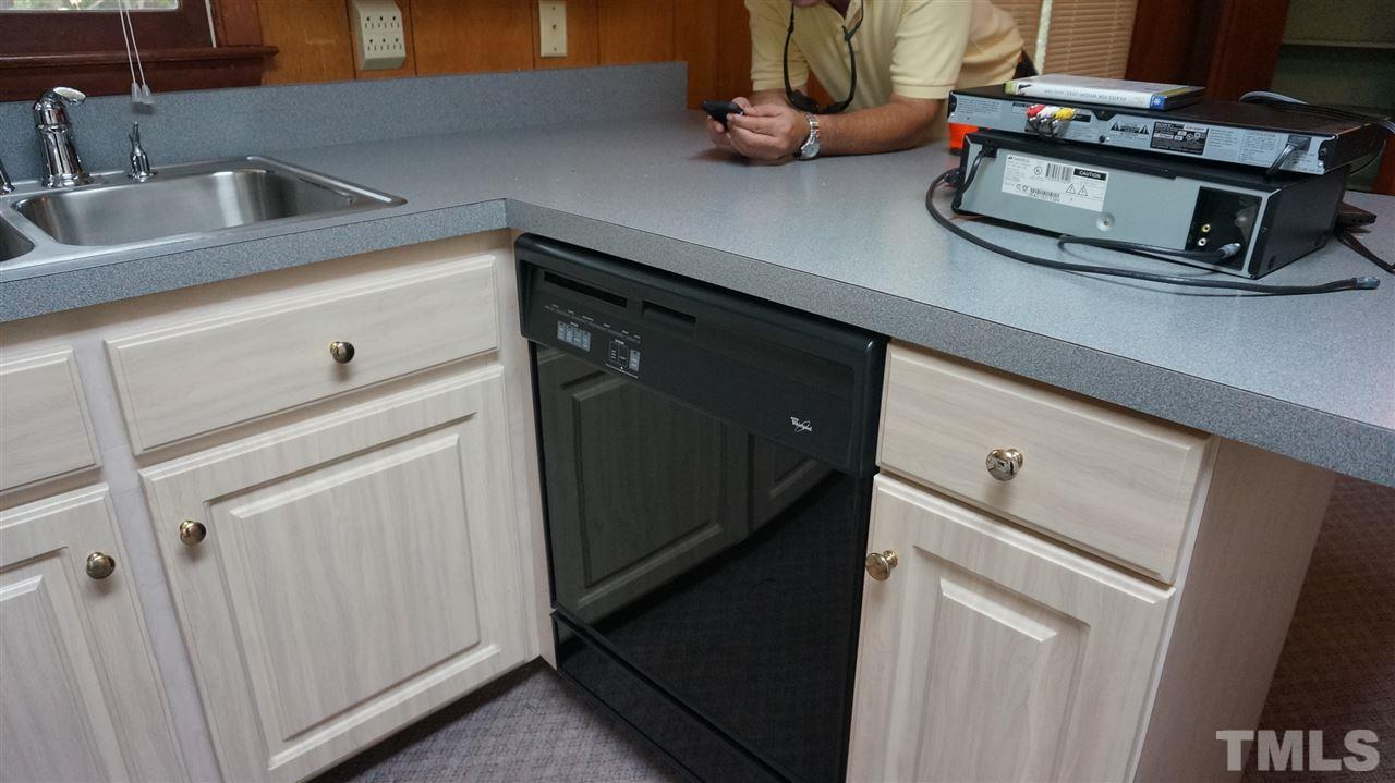 2613 Ramsey Road Raleigh, NC 27604 - Photo 15 of 23 a kitchen with a sink cabinets and appliances