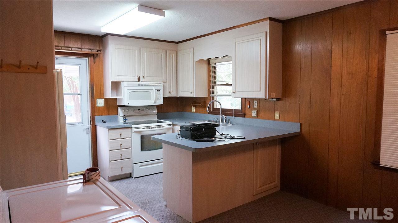 2613 Ramsey Road Raleigh, NC 27604 - Photo 8 of 23 a kitchen with stainless steel appliances granite countertop a sink stove and refrigerator