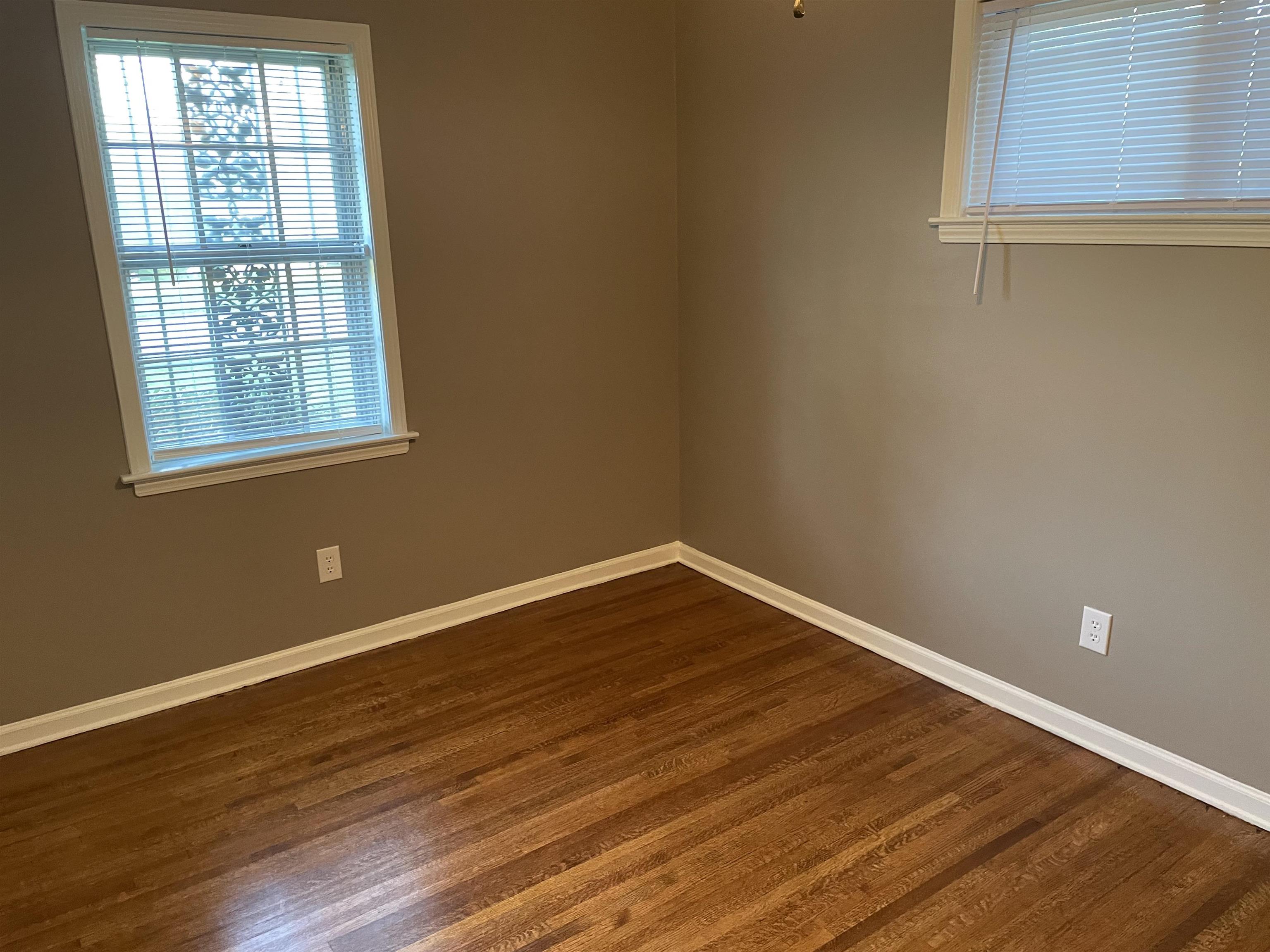 4615 Berta Road Memphis, TN 38109 - Photo 11 of 19 a view of an empty room with wooden floor and a window