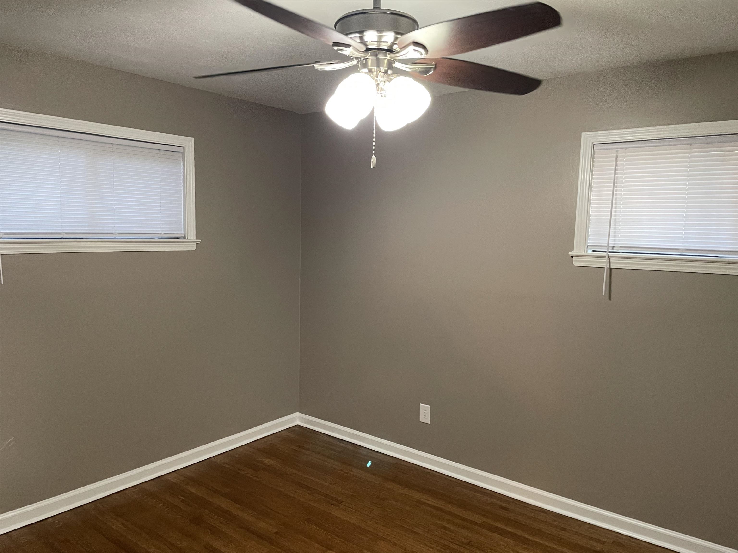 4615 Berta Road Memphis, TN 38109 - Photo 12 of 19 a view of a small space with wooden floor a chandelier fan and windows