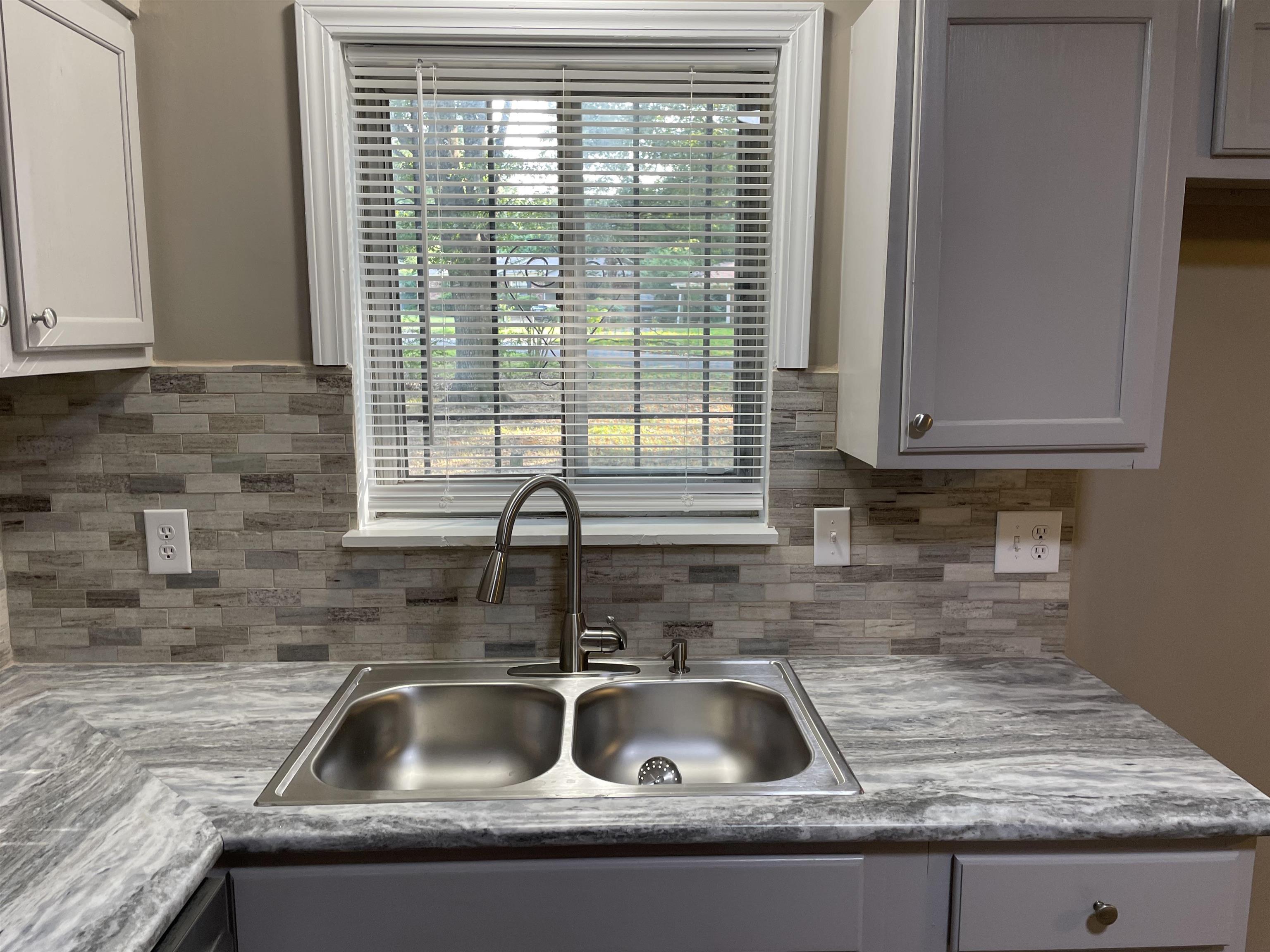 4615 Berta Road Memphis, TN 38109 - Photo 5 of 19 a kitchen sink with a granite countertop window