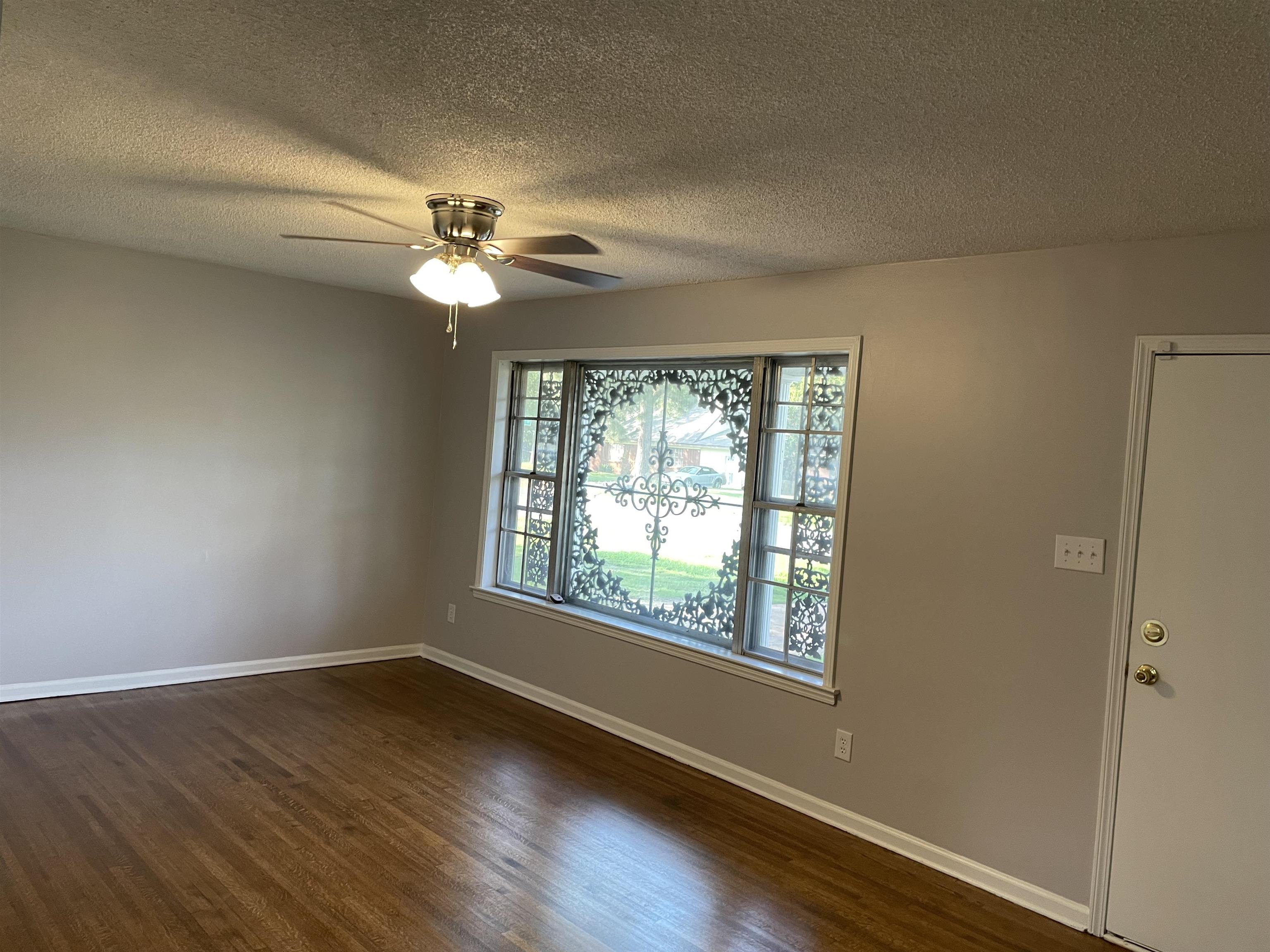 4615 Berta Road Memphis, TN 38109 - Photo 7 of 19 wooden floor in an empty room with a window