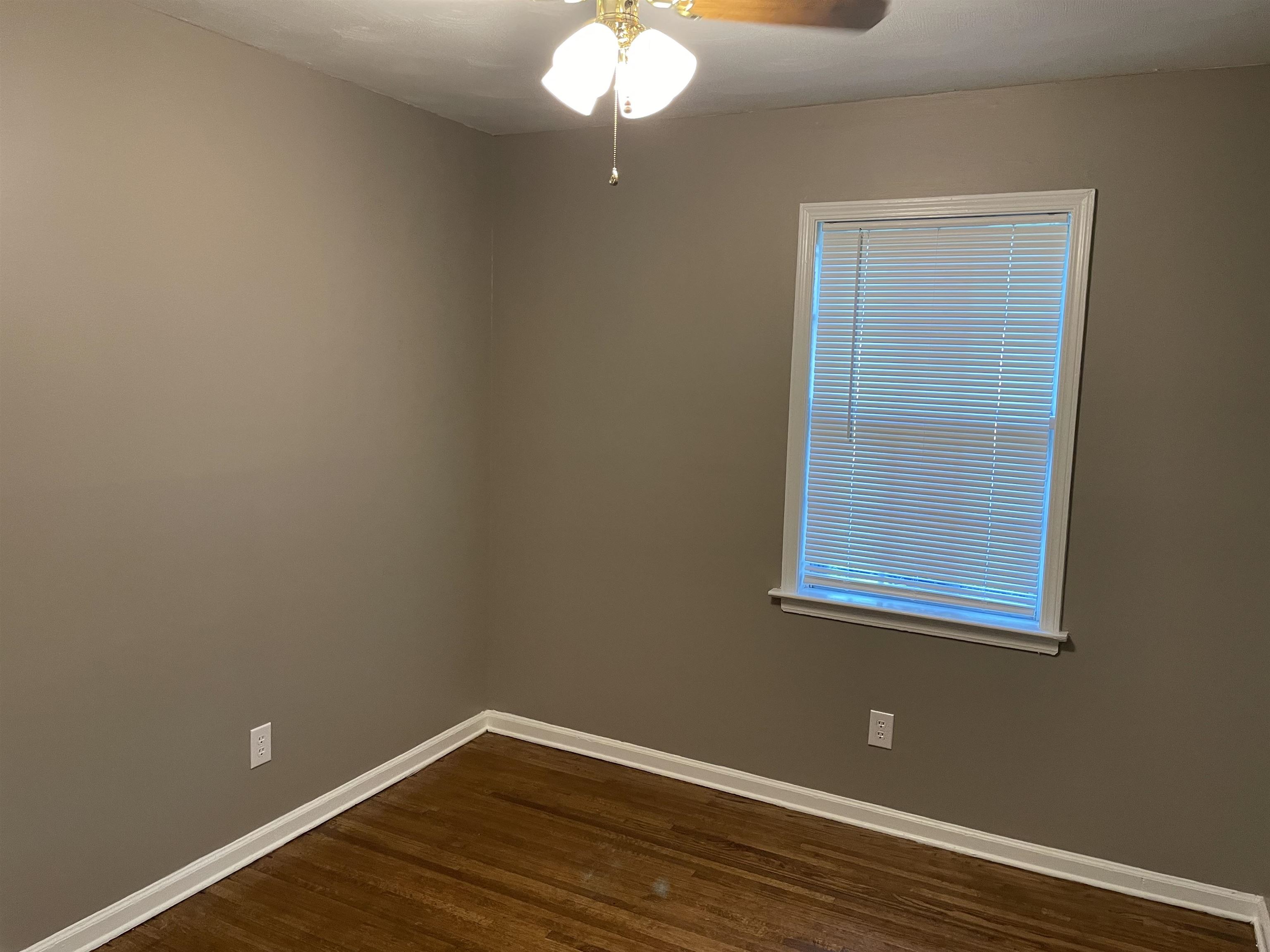 4615 Berta Road Memphis, TN 38109 - Photo 9 of 19 a view of a small space with wooden floor and a window