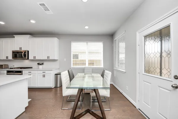 a kitchen with sink a microwave and refrigerator