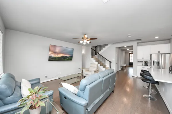 a living room with furniture and a wooden floor