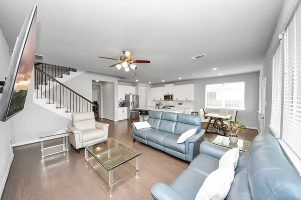 a living room with furniture and kitchen view
