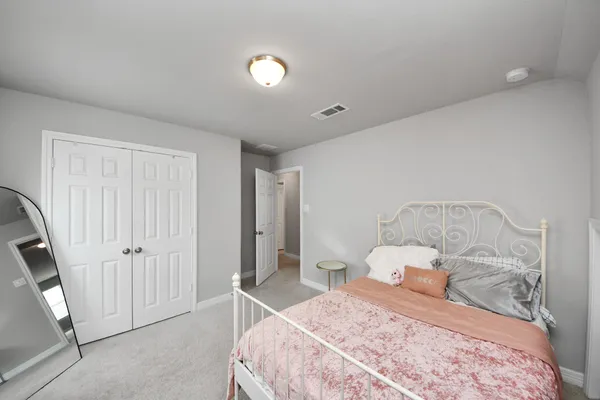 a bedroom with a bed and a chair