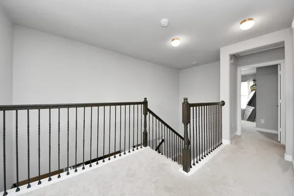 a bedroom with a bed and a flat tv screen on a dresser
