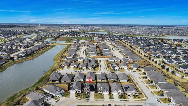 an aerial view of residential houses with outdoor space