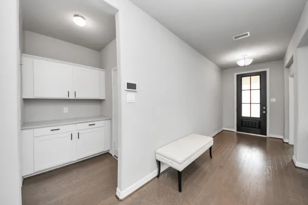 a view of a kitchen with wooden floor and windows