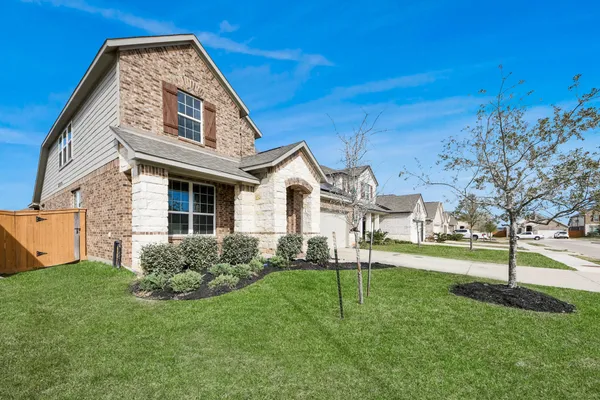 a view of a house with a yard and pathway