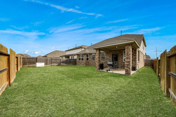 a view of a house with a backyard porch and sitting area