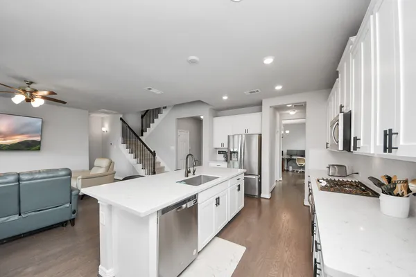 a large white kitchen with a large window