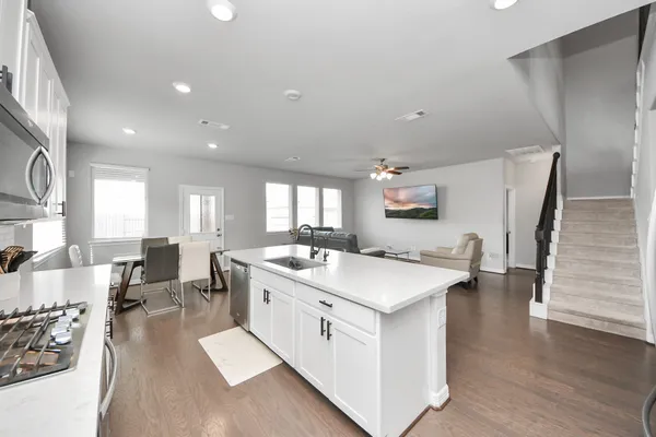 a large white kitchen with a large window