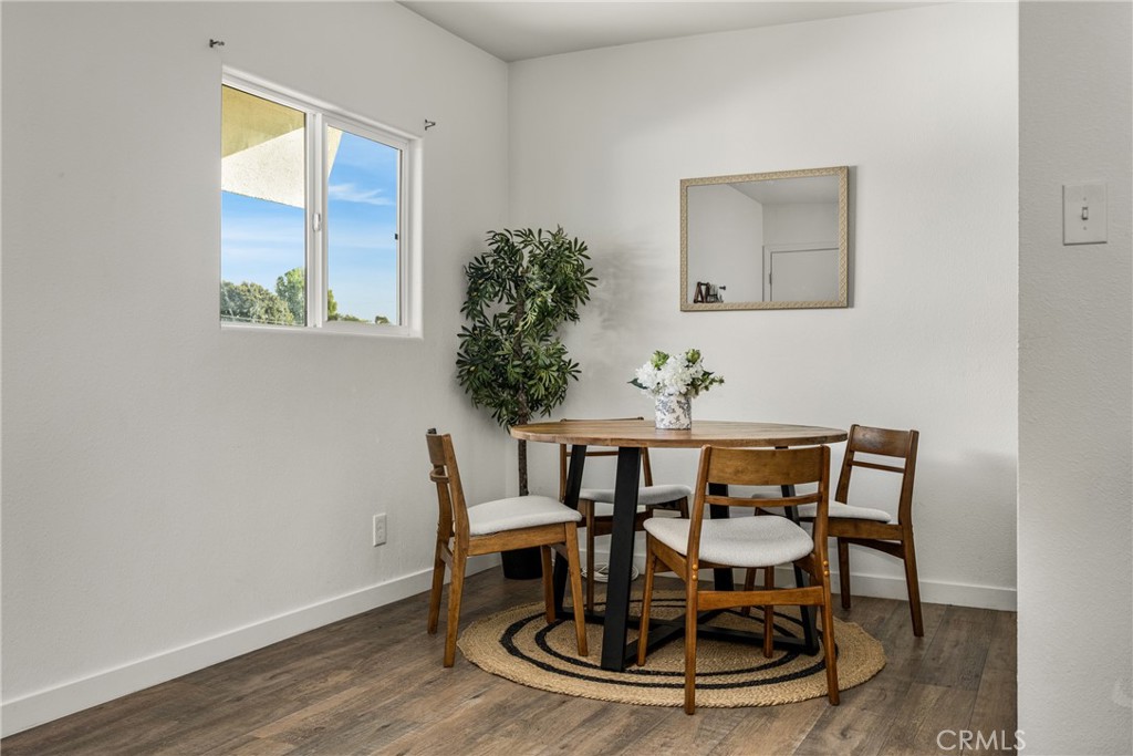 6725 Perry Road Bell Gardens, CA 90201 - Photo 19 of 40 a view of a dining room with furniture and wooden floor