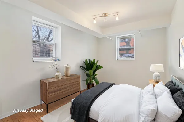 a bedroom with a bed and a painting on the wall