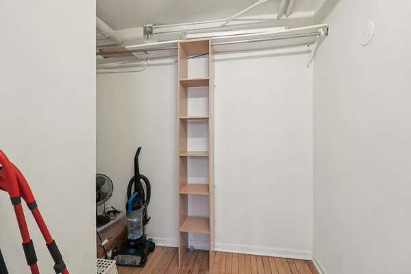 a view of walk in closet with clothes and shoes