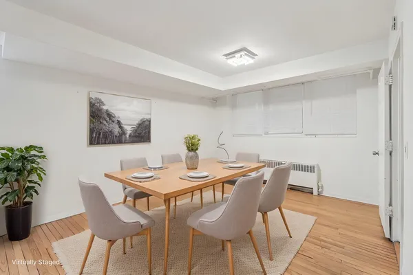 a view of a dining room with furniture and wooden floor