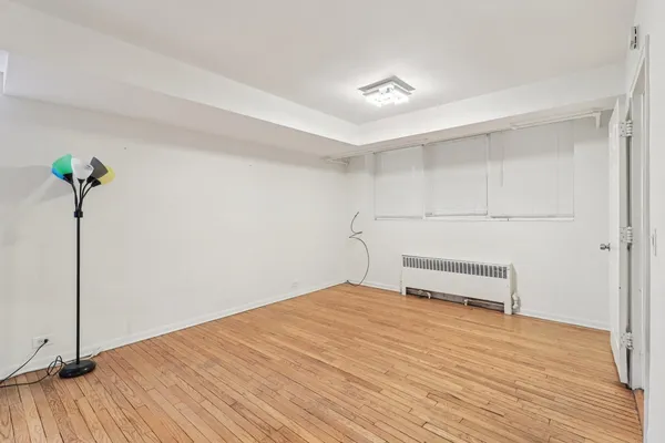 a view of a room with wooden floor