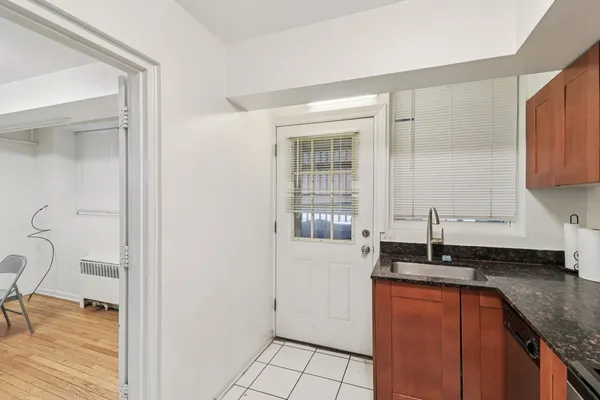 a kitchen with granite countertop a sink and a stove