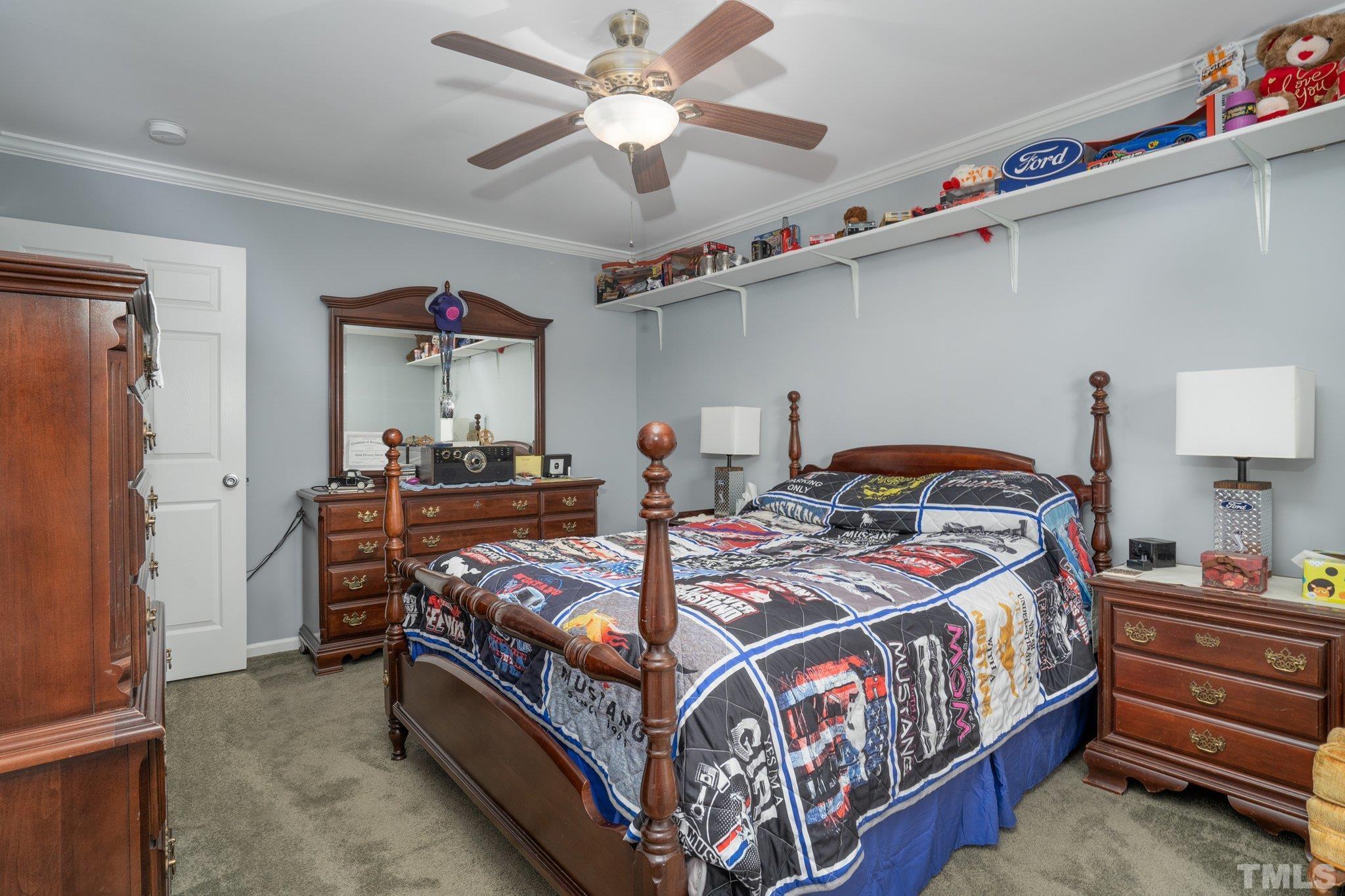 7349 Old Middlesex Road Bailey, NC 27807 - Photo 17 of 31 a bedroom with bed and a chandelier