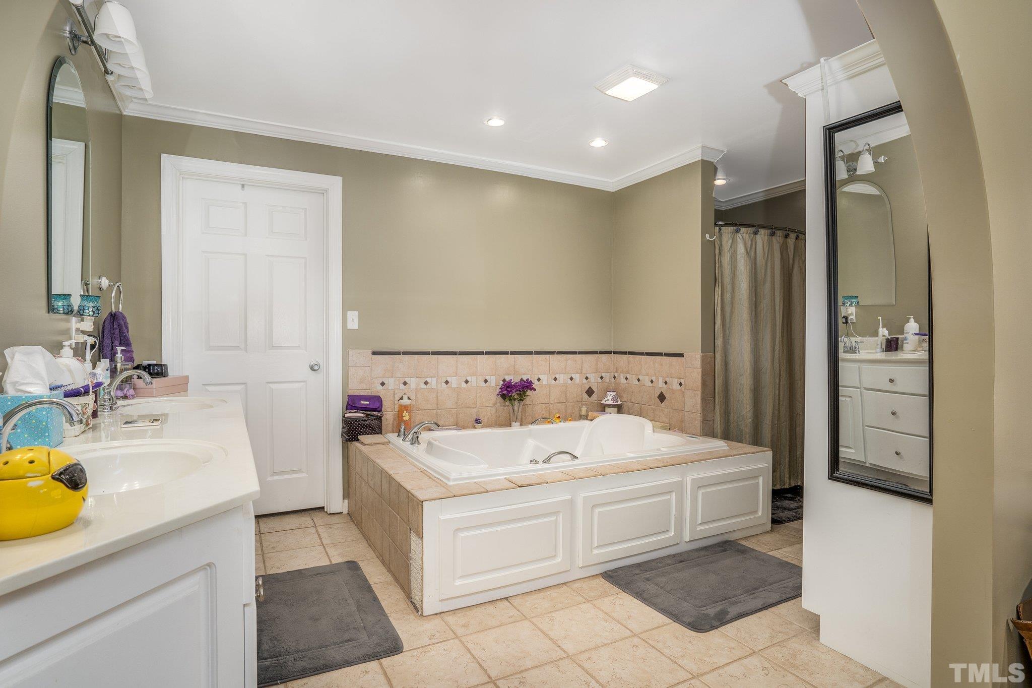 7349 Old Middlesex Road Bailey, NC 27807 - Photo 20 of 31 a spacious bathroom with a tub sink and mirror
