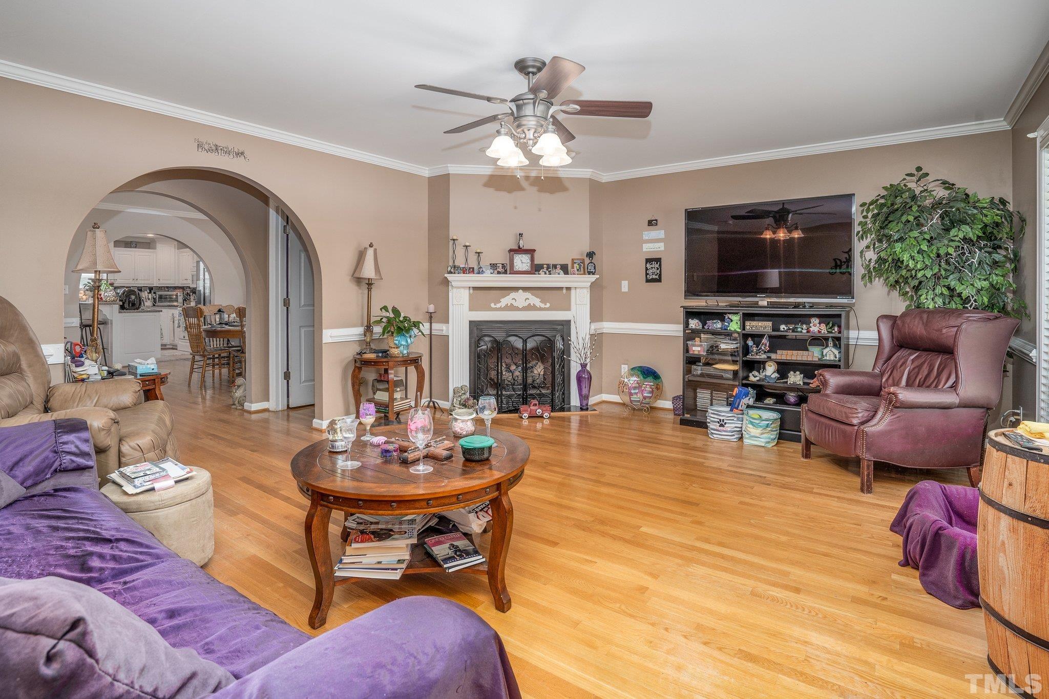 7349 Old Middlesex Road Bailey, NC 27807 - Photo 3 of 31 a living room with furniture a fireplace and a flat screen tv