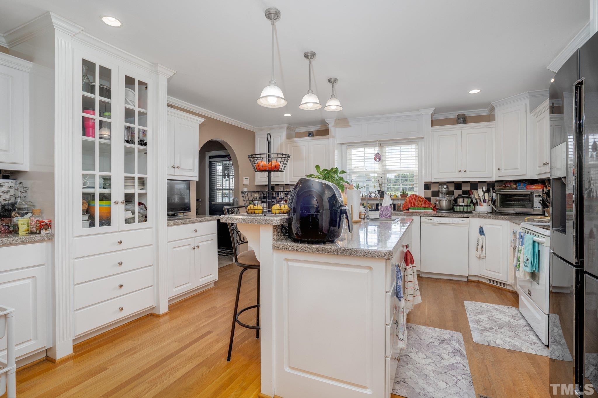 7349 Old Middlesex Road Bailey, NC 27807 - Photo 8 of 31 a kitchen with white cabinets and stainless steel appliances