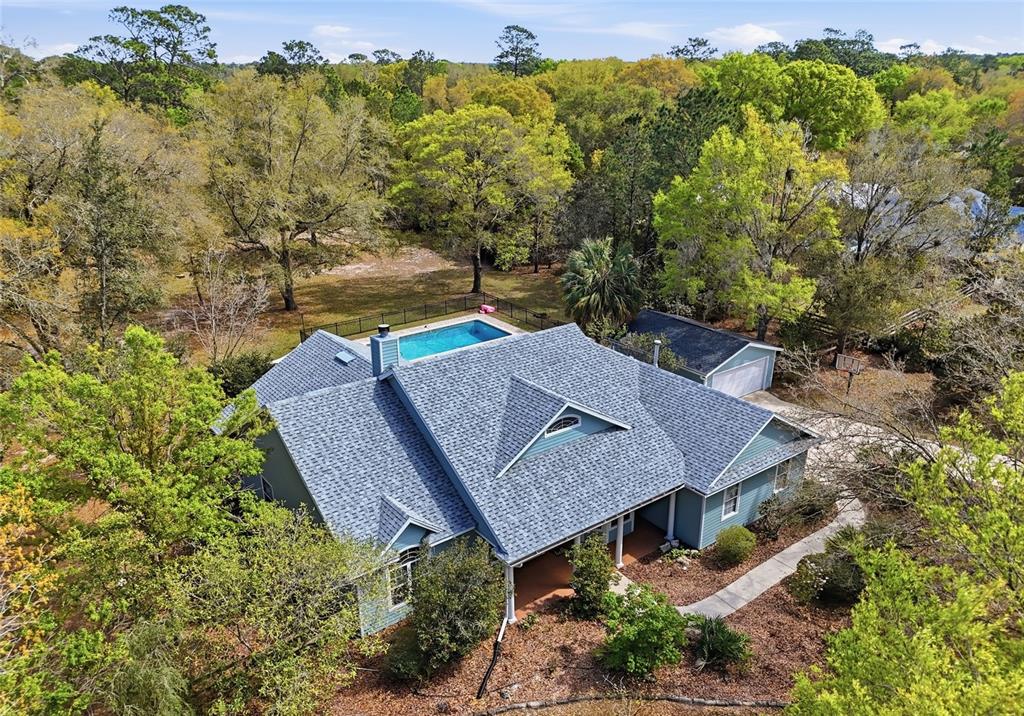 an aerial view of a house with a yard