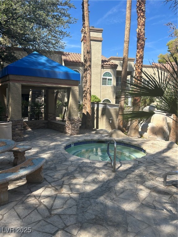 3145 East Flamingo Road, Unit 1014 Las Vegas, NV 89121 - Photo 4 of 17 View of pool with a community hot tub, a swimming pool, and a patio