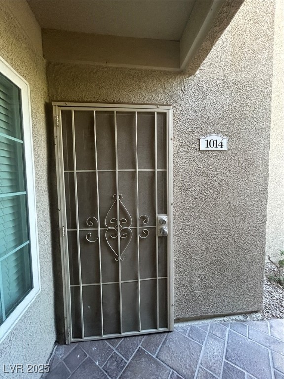 3145 East Flamingo Road, Unit 1014 Las Vegas, NV 89121 - Photo 5 of 17 View of exterior entry featuring stucco siding