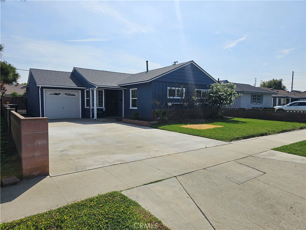 a front view of a house with yard and glass windows
