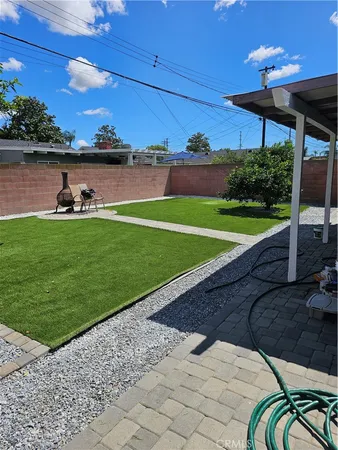 a view of a house with a backyard porch and sitting area