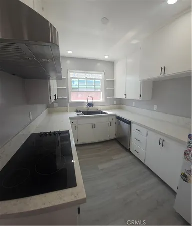a kitchen with a sink stove and cabinets