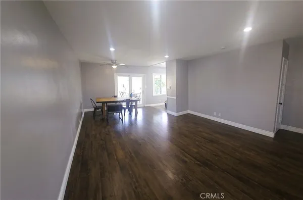 a view of wooden floor and windows in a room