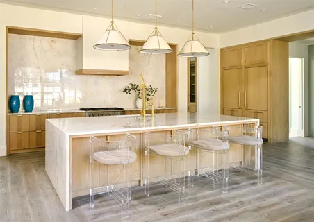 a bathroom with a sink a counter and a chair