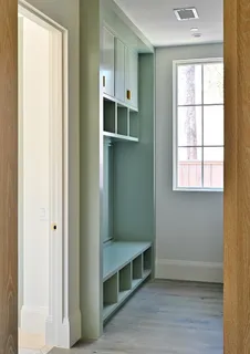 a view of an empty room with wooden floor and windows