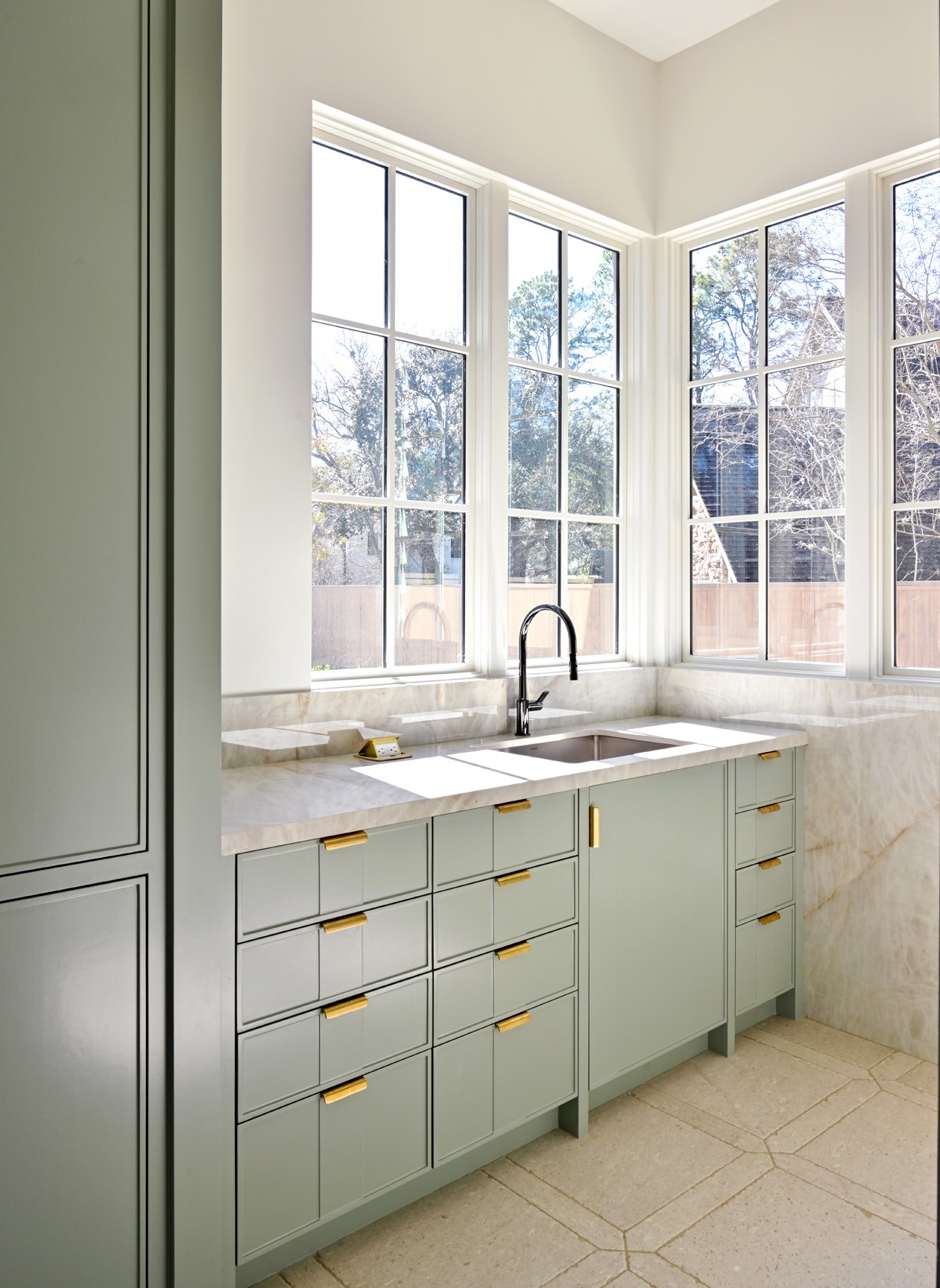 11710 Wendover Lane Houston, TX 77024 - Photo 20 of 50 Laundry room with built-in cabinetry and plenty of natural light