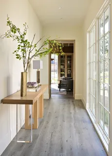 a living room with couches coffee table and chairs with wooden floor