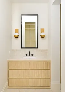 an empty room with wooden floor cabinet and windows