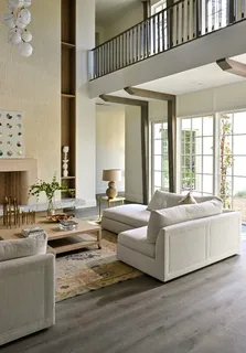 a living room with furniture and large windows