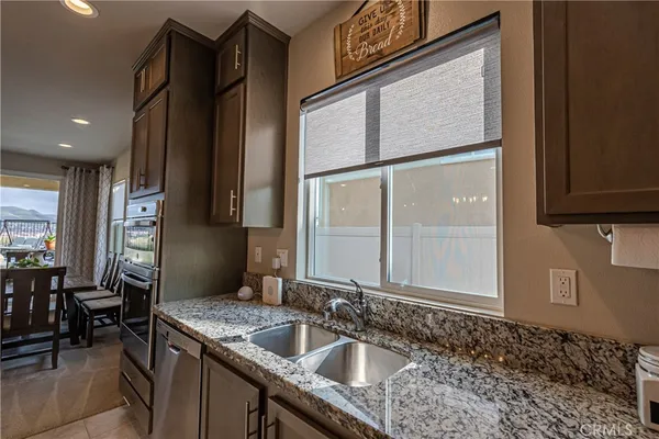 a kitchen with kitchen island granite countertop a table and chairs in it