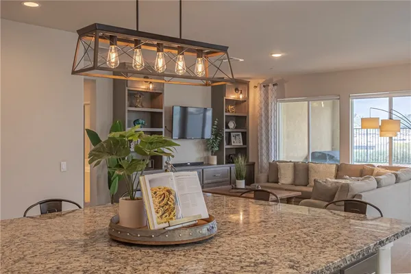 a kitchen with stainless steel appliances granite countertop a stove sink and cabinets
