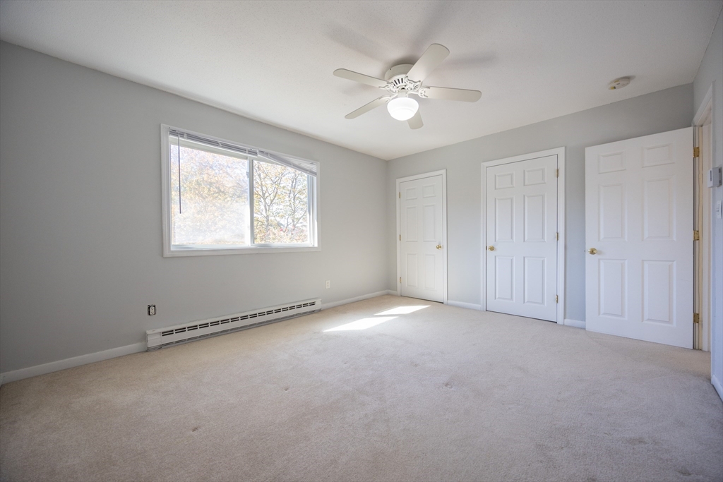 3 Dailey Street, Unit J Attleboro, MA 02703 - Photo 15 of 24 an empty room with chandelier fan and windows