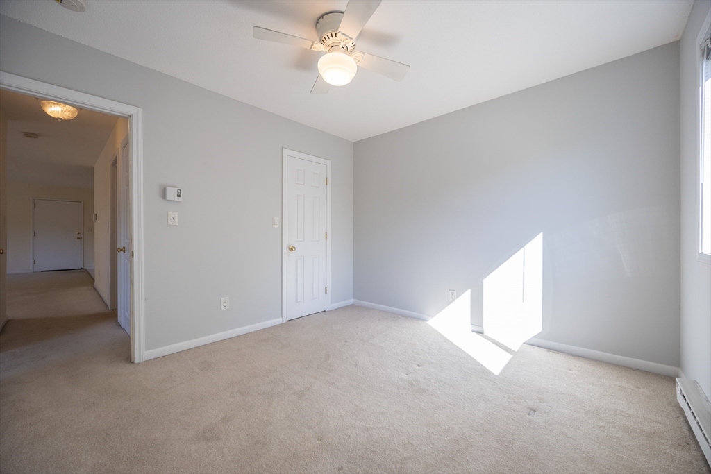 3 Dailey Street, Unit J Attleboro, MA 02703 - Photo 6 of 24 an empty room with a ceiling fan and a window